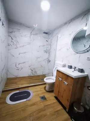 a bathroom with a toilet and a sink and a mirror at SokoStar Lux in Soko Banja