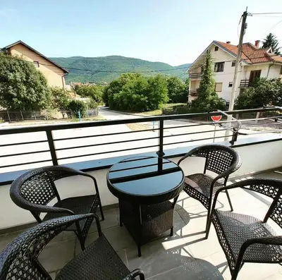 a patio with chairs and a table on a balcony at SokoStar Lux in Soko Banja