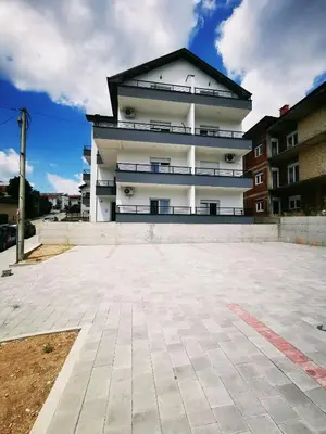 a large white building with a black roof at SokoStar Lux in Soko Banja