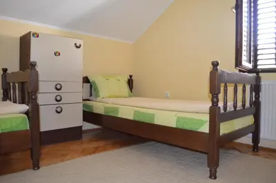 a bedroom with two bunk beds and a refrigerator at Smeštaj - sobe MARVEL in Niš