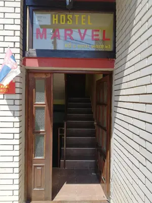 an entrance to a hospital with a door and stairs at Smeštaj - sobe MARVEL in Niš
