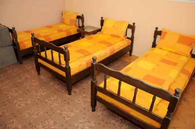 a group of three beds in a room at Smeštaj - sobe MARVEL in Niš