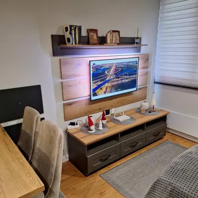 a living room with a desk with a television on it at Regulus apartment Brzeće Kopaonik in Brzeće