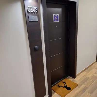 an elevator in a building with a sign on it at Regulus apartment Brzeće Kopaonik in Brzeće