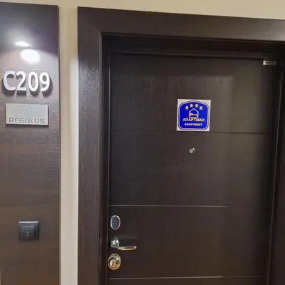 a door with a sign on it in a room at Regulus apartment Brzeće Kopaonik in Brzeće
