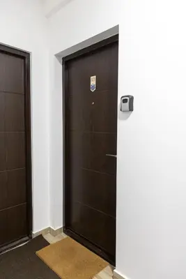 two sets of doors in a room with white walls at Glečer Kop, Cozy design apartment A5, FREE Parking Garage in Kopaonik