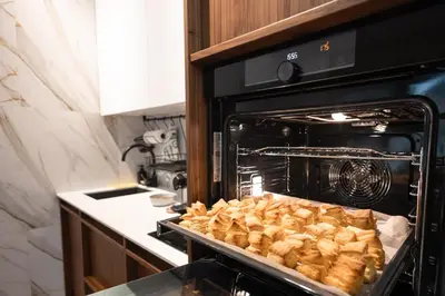 an oven with a tray of food in it at Glečer Kop, Cozy design apartment A5, FREE Parking Garage in Kopaonik