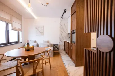 a kitchen and living room with a table and chairs at Glečer Kop, Cozy design apartment A5, FREE Parking Garage in Kopaonik