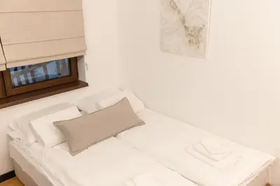 a white couch in a room with a window at Glečer Kop, Cozy design apartment A5, FREE Parking Garage in Kopaonik