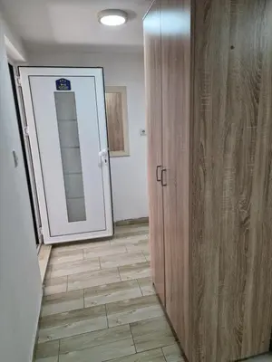 a room with a door and a mirror and a hallway at Zed Apartments in Leskovac