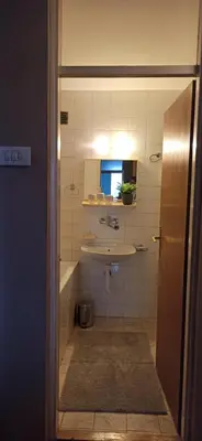 a bathroom with a sink and a mirror at Apartman Nissa in Niš