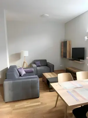 a living room with a couch and a table at SUNSKII Apartments in Brzeće