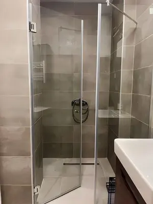 a shower with a glass door in a bathroom at SUNSKII Apartments in Brzeće