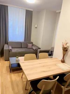 a living room with a table and a couch at SUNSKII Apartments in Brzeće