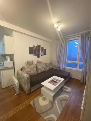 a living room with a couch and a table at Castello apartman Kopaonik Kraljevi Cardaci komplex in Kopaonik