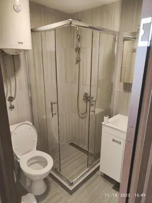 a bathroom with a shower with a toilet and a sink at Castello apartman Kopaonik Kraljevi Cardaci komplex in Kopaonik