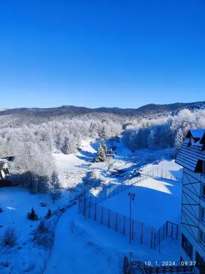 an aerial view of a snow covered field with a fence at Castello apartman Kopaonik Kraljevi Cardaci komplex in Kopaonik