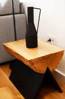 a wooden table with a black vase on top of it at UrbanKop Vidik Residence in Kopaonik