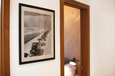 a black and white picture of a train on a wall at UrbanKop Vidik Residence in Kopaonik