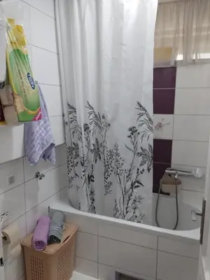 a bathroom with a shower curtain and a tub at Apartman Petra in Leskovac