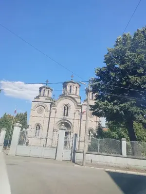 a large building with a fence in front of it at Apartman Petra in Leskovac