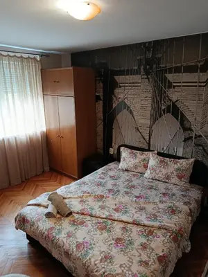 a bedroom with a bed with a teddy bear on it at Apartman Petra in Leskovac