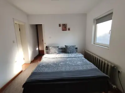 a bedroom with a bed and a window at Nikolic Apartment in Leskovac