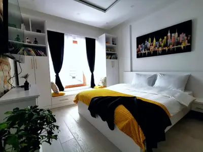 a bedroom with a bed with a yellow and black blanket at Golden Sky N Lux 57 Milmari Resort & Spa in Kopaonik