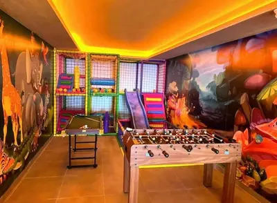 a room with a chess board in front of a mural at Golden Sky N Lux 57 Milmari Resort & Spa in Kopaonik