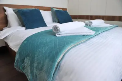 a bed with towels and pillows on it at Ramondia, Kopaonik in Kopaonik