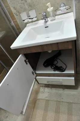 a bathroom with a white sink and a counter at Ramondia, Kopaonik in Kopaonik