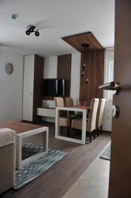 a living room with a white table and chairs at Ramondia, Kopaonik in Kopaonik