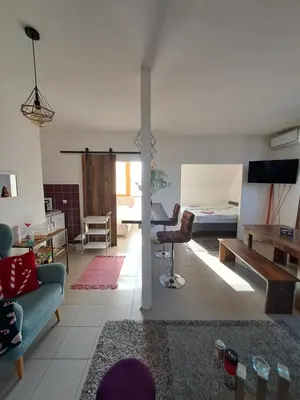 a living room with a couch and a bed at Sofi II in Niš