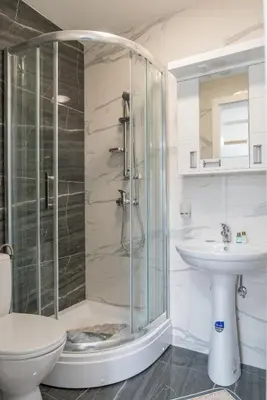 a bathroom with a shower and a toilet and a sink at Lucky Lux 1 i 2 Vrnjačka Banja in Vrnjačka Banja