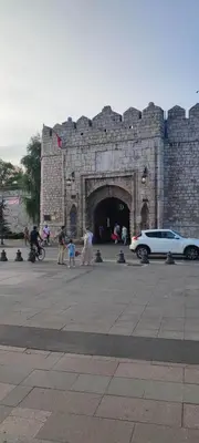 a group of people walking in front of a castle at Топ соба 12 in Niš