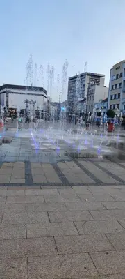 a water fountain in a square in a city at Топ соба 12 in Niš