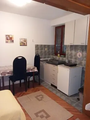 a kitchen with a table and chairs in a room at Vila Verica in Vrnjačka Banja