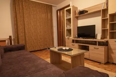 a living room with a couch and a tv at Apartman TWO in Magnohrom