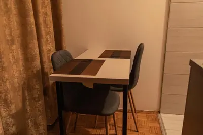 a table and two chairs in a room with a table at Apartman TWO in Magnohrom