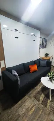 a living room with a blue couch and a table at Marinkovic 2 stan na dan in Vranje