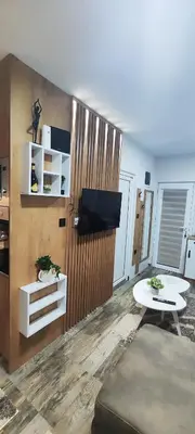 a living room with a tv and a table at Marinkovic 2 stan na dan in Vranje