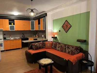 a living room with a couch and a kitchen at Jordan Apartman in Niška Banja