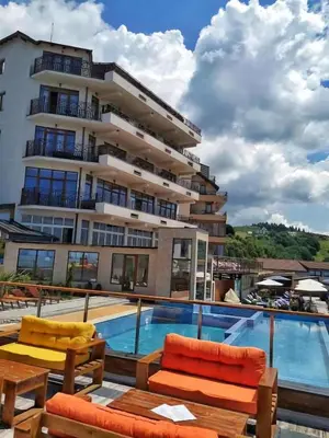 a hotel with a swimming pool and a building at Snežna pahuljica P19 in Kopaonik