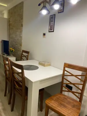 a kitchen with a white table and chairs at Snežna pahuljica P19 in Kopaonik