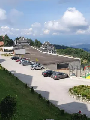 a parking lot with a bunch of cars parked at Snežna pahuljica P19 in Kopaonik