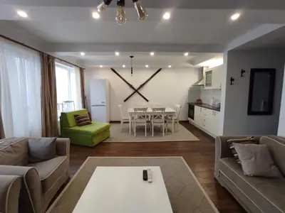 a living room with a large clock on the wall at Apartment Panorama 3 in Kopaonik