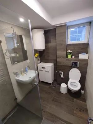 a bathroom with a toilet and a sink at Apartment Panorama 3 in Kopaonik