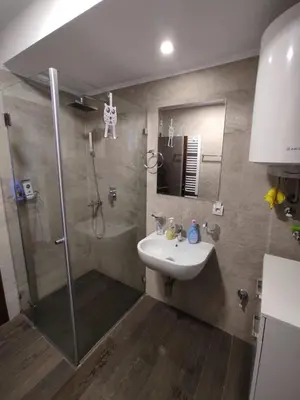 a bathroom with a shower and a sink and a shower at Apartment Panorama 3 in Kopaonik
