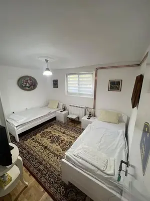 a room with two beds and a couch in it at Apartment Milinković 2 in Kovanluk