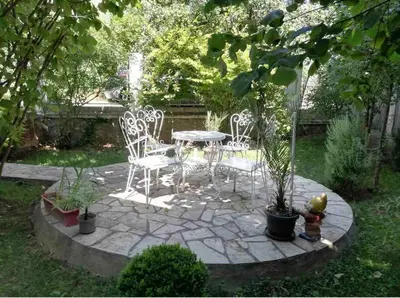 a patio with a table and chairs and a fountain at Apartment Milinković 2 in Kovanluk